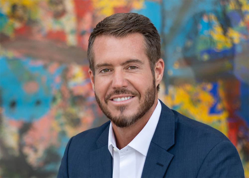 a man in suit with a colorful background